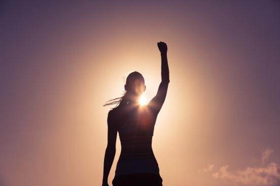 Victorious female athlete with fist raised