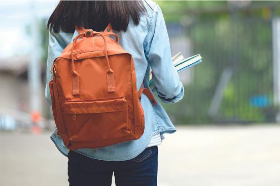 Teen girl with backpack and books