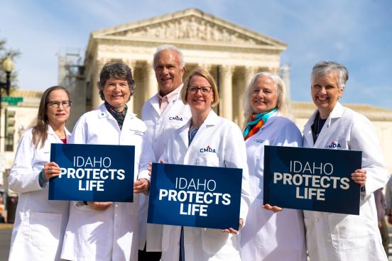 Idaho doctors holding signs in front of SCOTUS