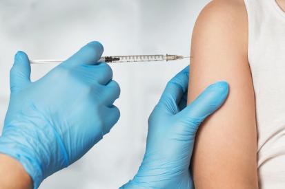 Doctor with gloves giving a vaccine shot