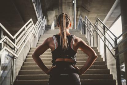 Female athlete staring at stairs