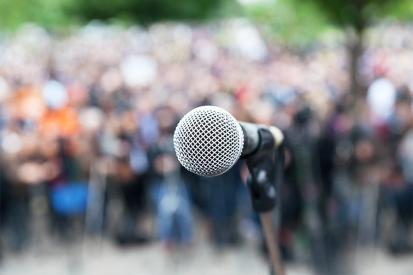 A microphone is seen set up before a crowd