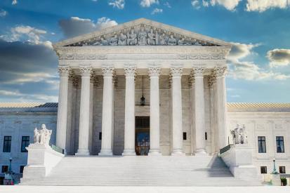 The front of the U.S. Supreme Court with clouds in the background