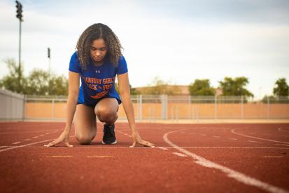 Alanna Smith, a track athlete from Connecticut, crouches on the track