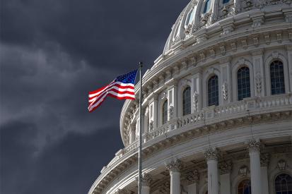 The dome of the U.S. Capitol is seen against a dark, cloudy sky