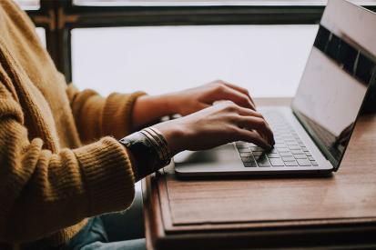 Woman typing on a laptop computer