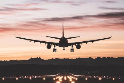 Airplane landing at an airport at sunrise