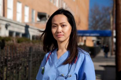 Nurse Cathy Cenzon-DeCarlo is seen standing outside the hospital wearing her scrubs