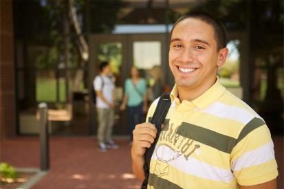 Christian Andzel standing in front of school building