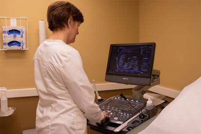 A CompassCare nurse looks at an ultrasound