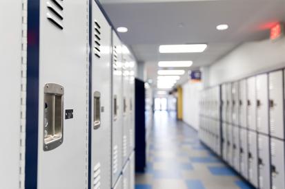 Lockers are seen lining an empty school hallway