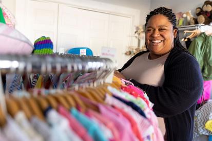 Pregnancy center director Jean Marie Davis stands among racks of clothing at Branches Pregnancy Center