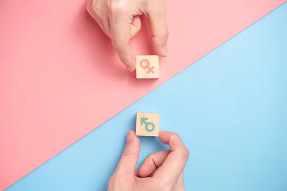 Symbols for male and female are displayed on a pink and blue background