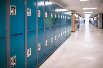 Blue lockers line an empty school hallway