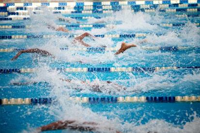 Swimmers race in a pool