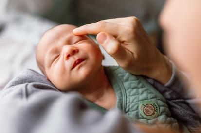 A cradled baby with its eyes closed