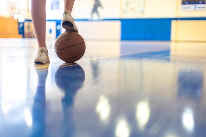 Rapides School District gym with girl with foot on basketball