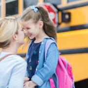 Mother and Daughter by school bus