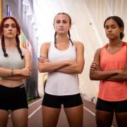 Selina Soule, Chelsea Michell, and Alanna Smith standing on the track serious