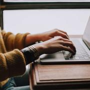 Woman typing on a laptop computer