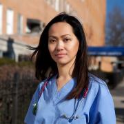 Nurse Cathy Cenzon-DeCarlo is seen standing outside the hospital wearing her scrubs