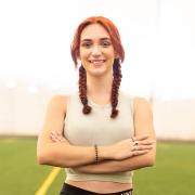 Selina Soule standing on an indoor field