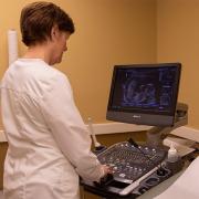 A CompassCare nurse looks at an ultrasound