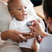 Pediatrician doctor doing a checkup on a baby