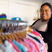 Pregnancy center director Jean Marie Davis stands among racks of clothing at Branches Pregnancy Center