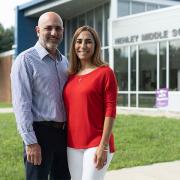 Carlos and Tatiana Ibanez standing in front of Henley Middle School