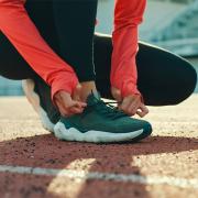 Female track athlete tying her shoes