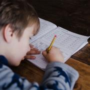 A boy student doing his homework