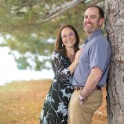 Joe and Serena Wailes smile as they lean against a tree