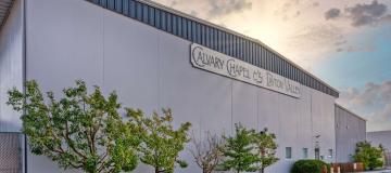 Calvary Chapel building sunlit with trees