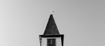 Black-and-white photo of a church steeple