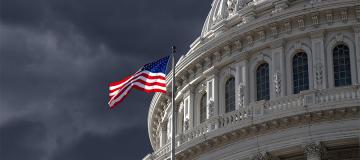 The dome of the U.S. Capitol is seen against a dark, cloudy sky