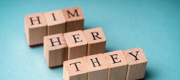 Pronouns are spelled out in wooden letter blocks 