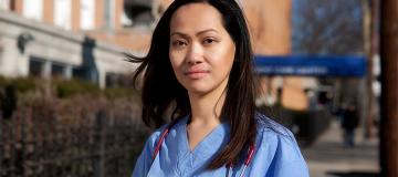 Nurse Cathy Cenzon-DeCarlo is seen standing outside the hospital wearing her scrubs