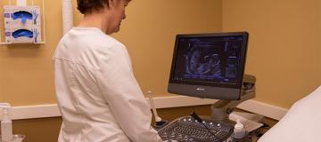 A CompassCare nurse looks at an ultrasound