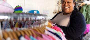 Pregnancy center director Jean Marie Davis stands among racks of clothing at Branches Pregnancy Center