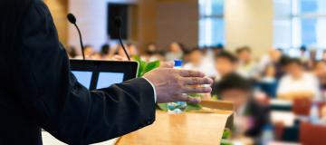 A lecturer addresses a college classroom