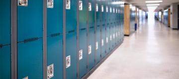 Blue lockers line an empty school hallway