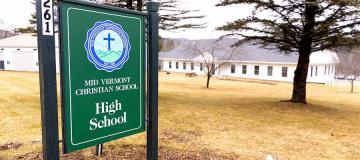 A sign for Mid Vermont Christian School is seen on campus