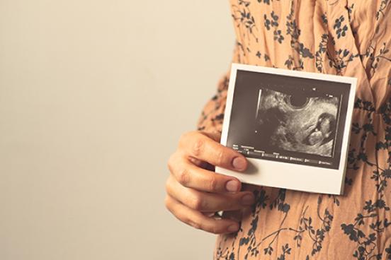 pregnant woman holding ultrasound