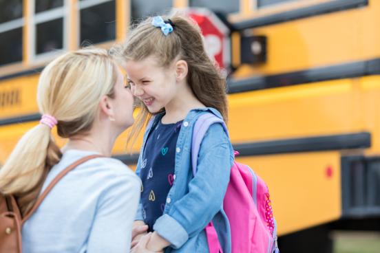 Mother and Daughter by school bus