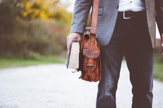 Man walking with Bible and briefcase