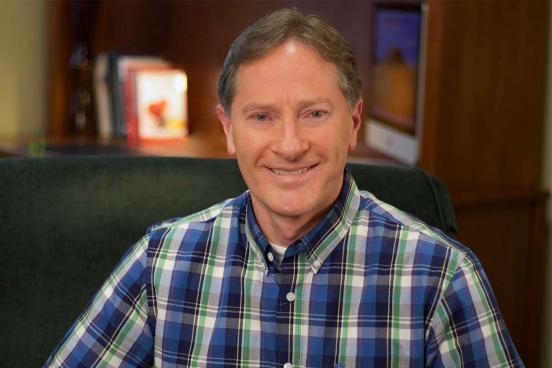 Counselor Brian Tingley is seen sitting at his desk