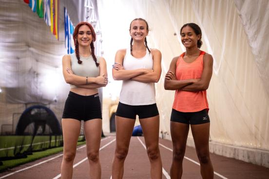 Selina Soule, Chelsea Michell, and Alanna Smith standing on the track smiling