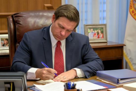 Ron Desantis signing a bill