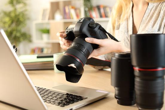 Female photographer with her camera and laptop